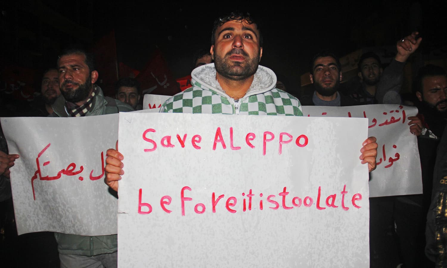 Syrians shout slogans during a rally in the rebel-held northwestern city of Idlib, late on December 12, 2016, in support of residents of the rebel-controlled part of Aleppo which is under regime siege. ─ AFP