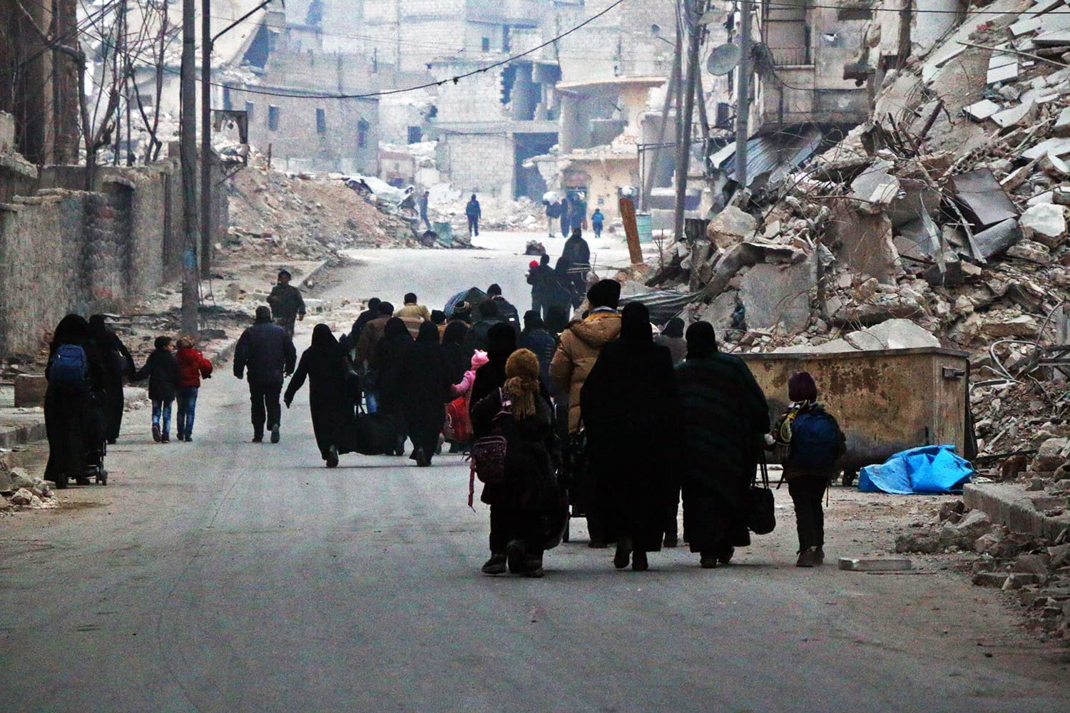 Syrian civilians flee the Sukkari neighbourhood towards safer rebel-held areas in southeastern Aleppo, on December 12, 2016, during an operation by Syrian government forces to retake the embattled city. ─ AFP