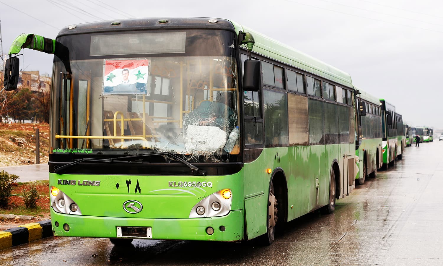 Buses wait to evacuate people from a rebel pocket in Aleppo, in the government-controlled al-Hamadaniah Stadium of Aleppo, Syria December 14, 2016. ─ Reuters