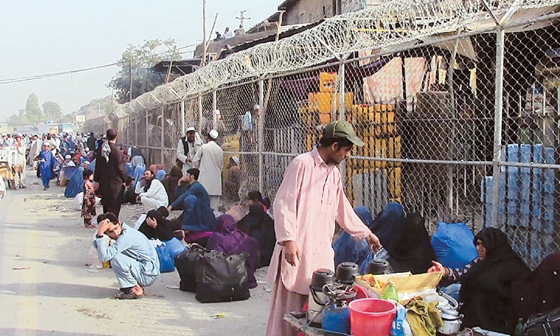 Afghan nationals at the Torkham border waiting to cross into Afghanistan. Guards at the border made announcemt through loudspeakers warning the Afghans against travelling without valid papers &mdash; Photos by Abdul Majeed Goraya/White Star