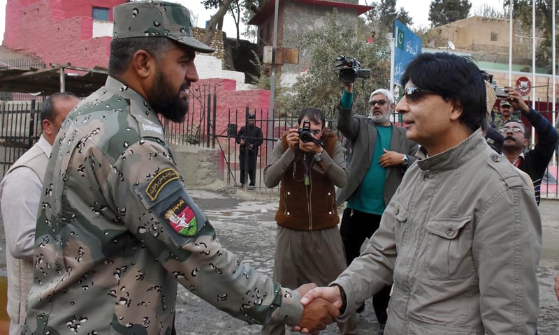 TORKHAM:  Interior Minister Chaudhry Nisar Ali Khan shakes hands with an Afghan security officer during his visit to the border here on Wednesday.&mdash; INP