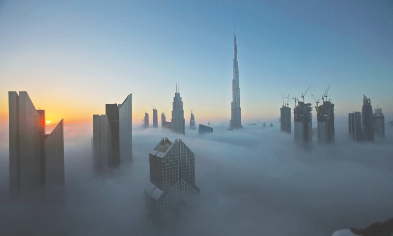Dubai: The sun rises over the city skyline with the Burj Khalifa, world&rsquo;s tallest building at the backdrop, seen from a balcony on the 42nd floor of a hotel on a foggy day here on Saturday.&mdash;AP