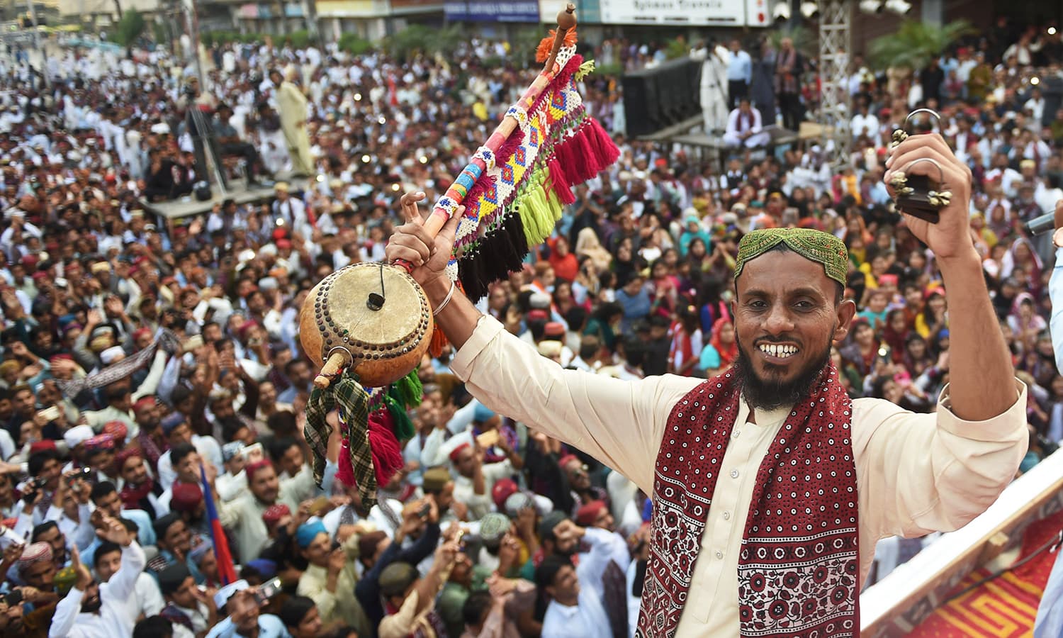 A Sindhi folk singer wearing traditional Sindhi cap and Ajrak performs during a Sindh Cultural Day festival in Karachi.— AFP