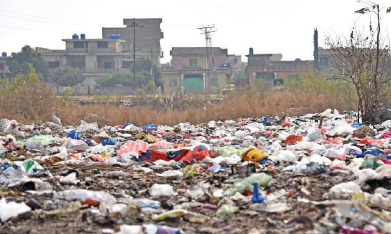 Waste has been openly dumped near a locality in Bhara Kahu. &mdash; Dawn