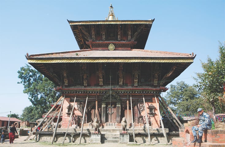 A Nepalese policeman rests in front of the fifth century temple, Changu Narayan.&mdash;AP