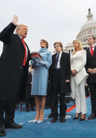 WASHINGTON: US President Donald Trump takes the oath of office as his wife Melania holds the bible and his children watch. US Supreme Court Chief Justice John Roberts (not seen in the picture) administered the oath.—Reuters