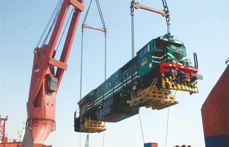 KARACHI : A locomotive being offloaded from a ship at the Karachi port on Monday.—APP