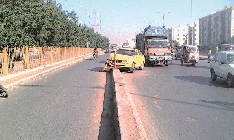 A TAXI crashes into the median of a U-turn near a bus stop in North Karachi. 