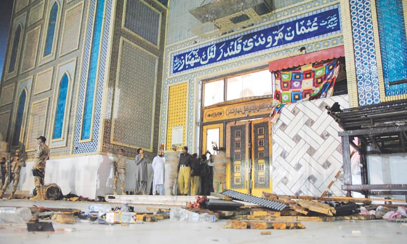 THE floor of the shrine is strewn with debris as security personnel gather at the place after the blast on Thursday. —Photo by Yousuf Nagori