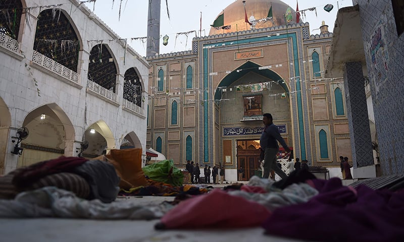 Security personnel stand guard at the 13th century Muslim Sufi shrine of Lal Shahbaz Qalandar