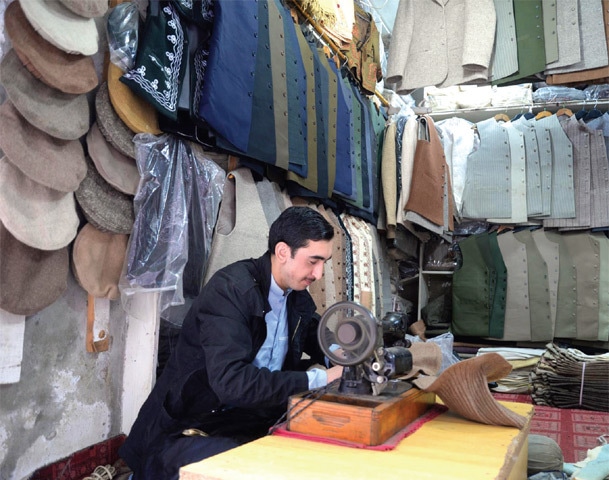 A worker makes a cap at his shop in Chitrali Bazaar, Peshawar. &mdash; Dawn