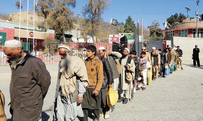 TORKHAM: Afghan nationals detained under the Foreigners Act being handed over to their country&rsquo;s security authorities on the border on Tuesday.&shy;&mdash;INP