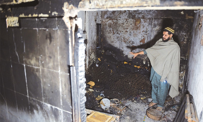 Mohammad Umair, who lost his three children in a home fire, inside his apartment.&mdash;AFP