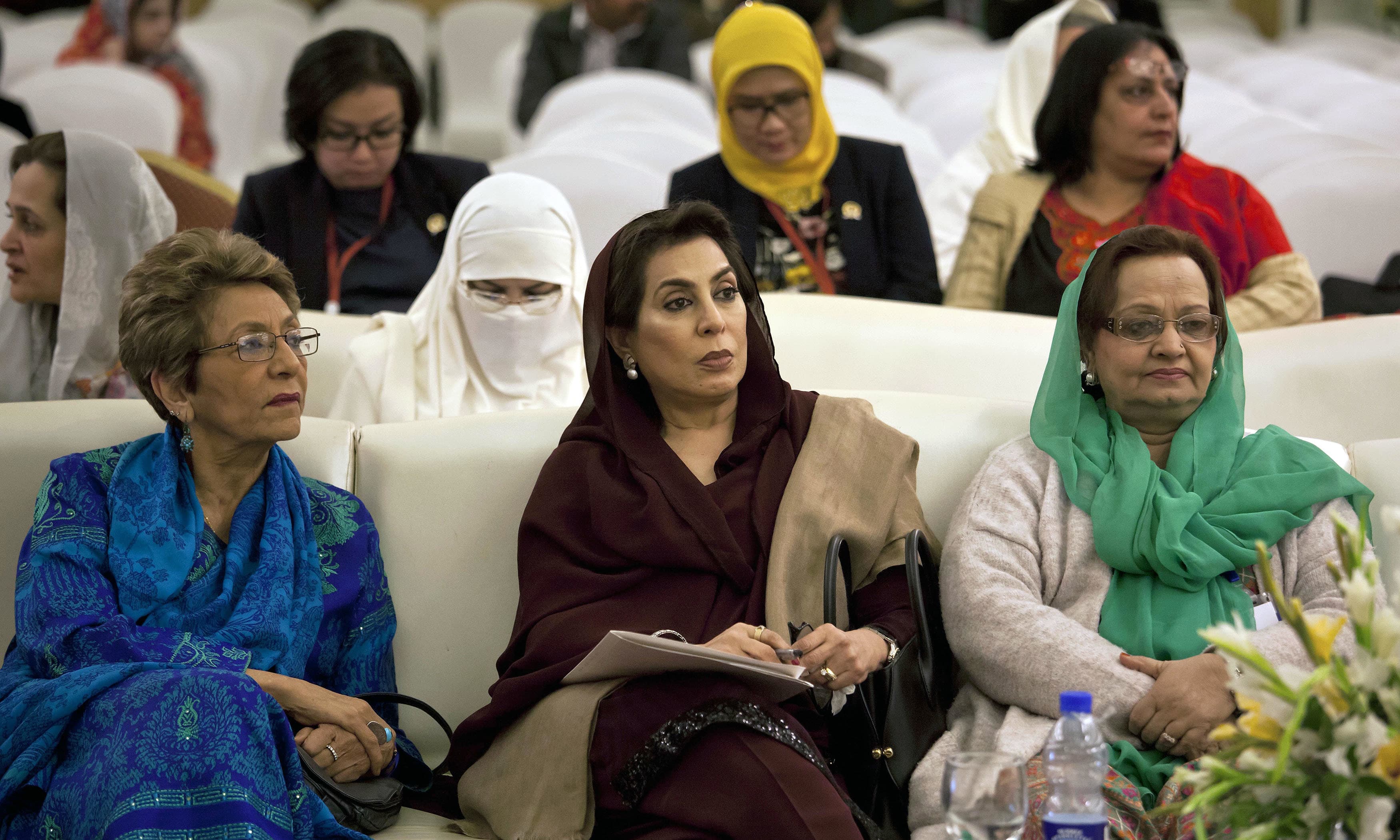 Women lawmakers Tahira Aurangzeb, Fahmida Mirza and other women attend an international women's conference in Islamabad. —AP