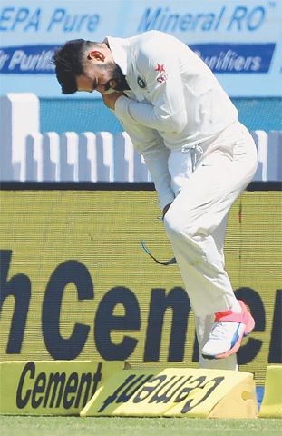 INDIAN captain Virat Kohli holds his shoulder after getting injured while fielding.&mdash;AFP