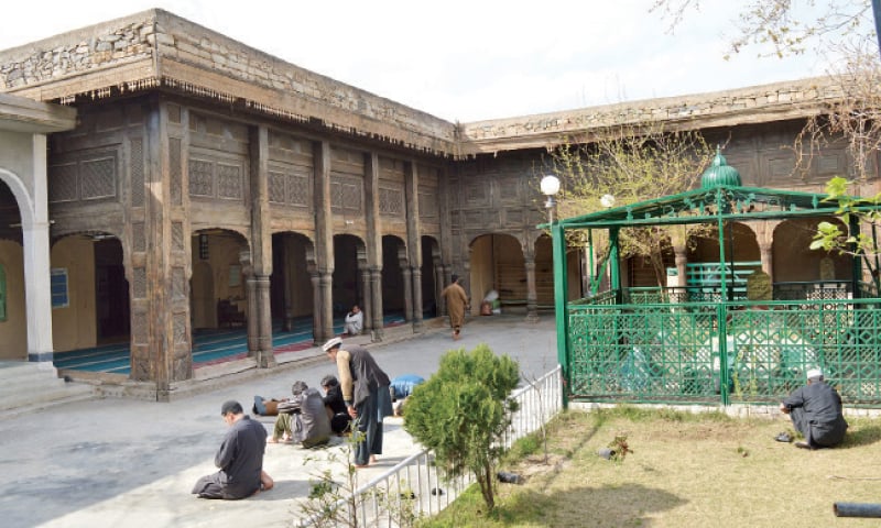 People pray at Babaji Mosque in Timergara. &mdash; Dawn