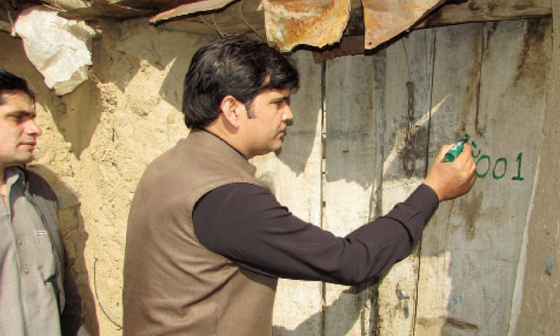 Political agent Khalid Iqbal marks a house in Orakzai Agency on Friday. — Dawn Political agent Khalid Iqbal marks a house in Orakzai Agency on Friday. — Dawn