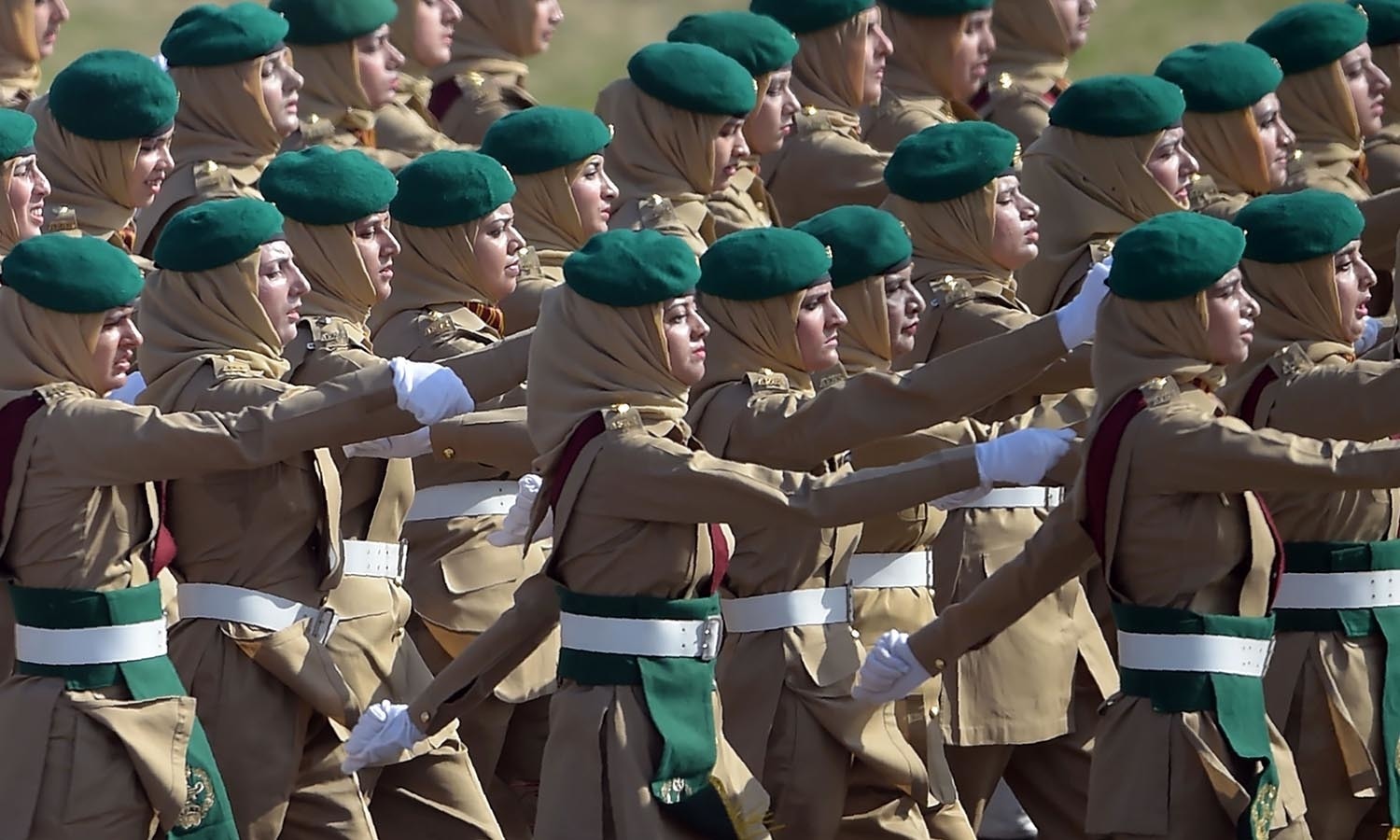 Female Pakistani army soldiers march past during a Pakistan Day military parade.─AFP