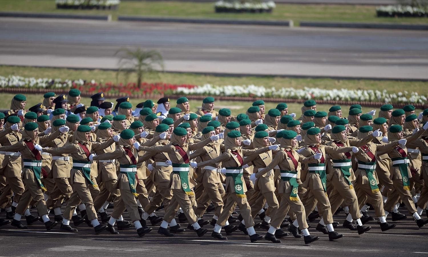 Pakistani women army soldiers march past during a Pakistan Day military parade.─AFP