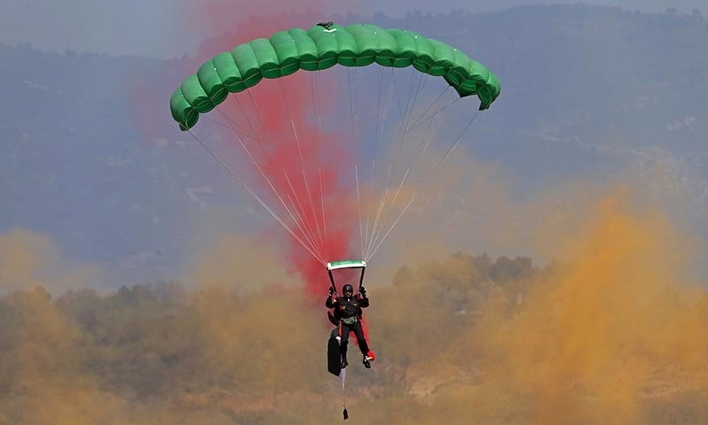 A Pakistan army paratrooper performs during a military parade to mark Pakistan's Republic Day.─AP