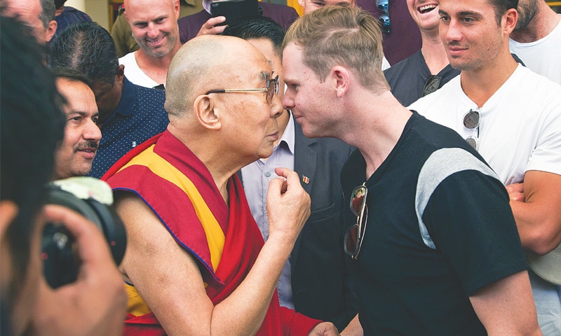 DHARMSALA: Tibetan spiritual leader the Dalai Lama and Australian captain Steven Smith rub their noses during an interaction at the Tsuglakhang temple on Friday. The Australian team held a relaxing session with the Dalai Lama where they learnt about keeping their cool, just a day ahead of the high-pressure series decider against India.—AP