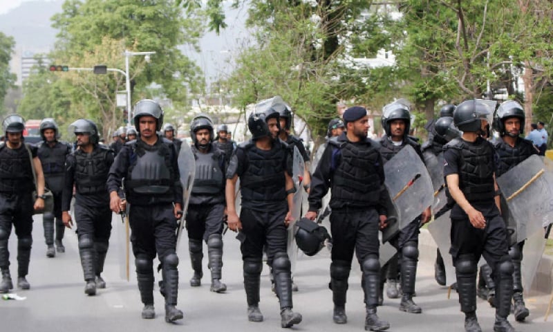 Riot police head towards the Lal Masjid on Friday. — Online