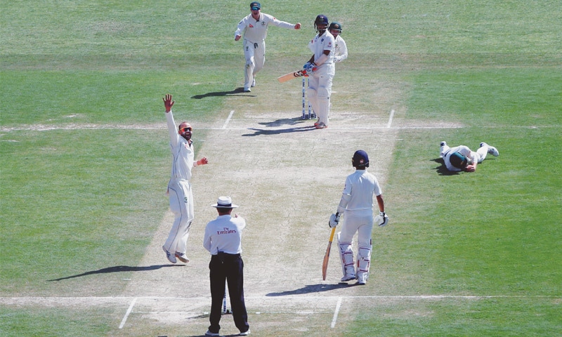 Dharamsala: Australian spinner Nathan Lyon appeals successfully for the dismissal of Indian batsmen Cheteshwar Pujara, caught by Peter Handscomb (R), during the fourth Test at HPCA Stadium on Sunday ─ Reuters