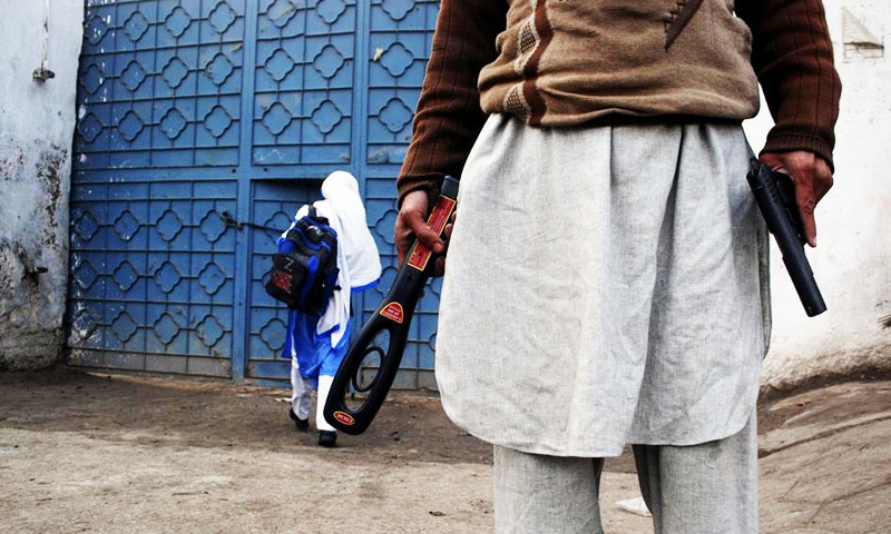 A guard with a gun and a metal detector stands outside a school after it reopened in Peshawar, January 2015. —Reuters/File A guard with a gun and a metal detector stands outside a school after it reopened in Peshawar, January 2015. —Reuters/File