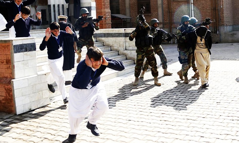School children flee as soldiers conducting an exercise to repel militant attacks detain a mock-militant.—Reuters/File