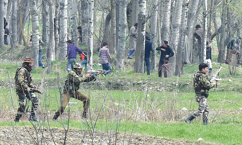 KASHMIRI protesters run after Indian security personnel used live ammunition near the site of a gun battle between suspected militants and Indian soldiers in Chadoora, in the Badgam district of Srinagar, on Tuesday.—AFP