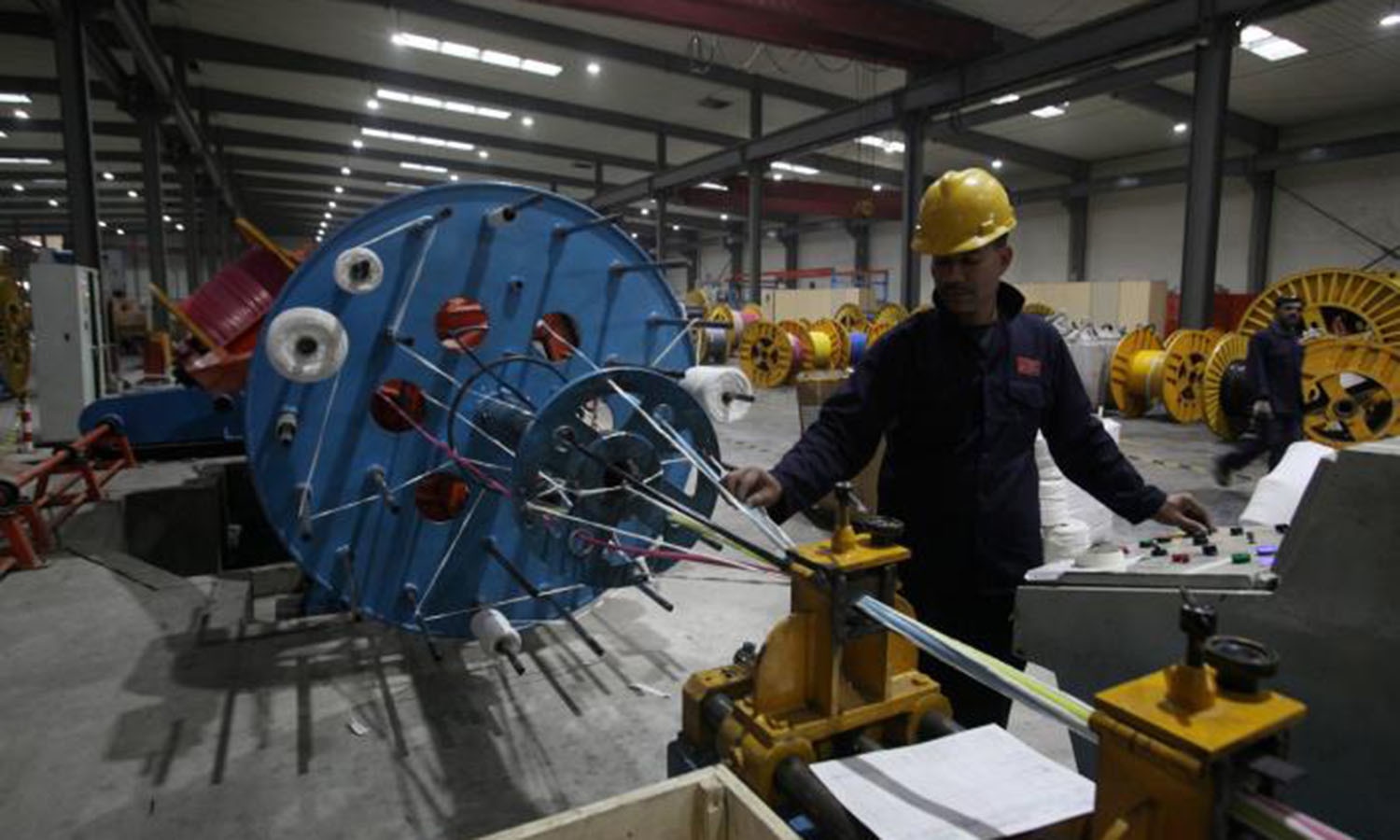 A worker monitors automatic copper wire unit at Pakistan Cables in Karachi.─Reuters