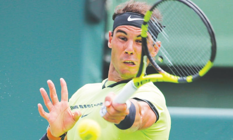 RAFAEL Nadal of Spain hits a return to Switzerland’s Roger Federer during the Miami Open decider.—AP