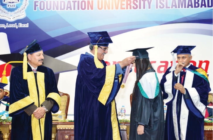 The managing director of Fauji Foundation and President Foundation University Islamabad, retired Lt Gen Khalid Nawaz Khan awards students at the convocation. &mdash; Dawn
