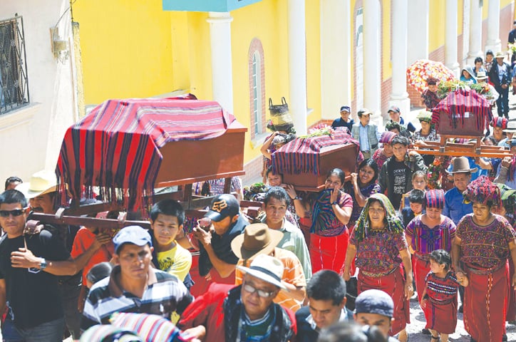 people carry coffins of victims of a 1982 massacre, in Nebaj, Quiche department some 260km northwest of Guatemala City, in this file picture taken on July 30, 2014. According to a UN report, 200,000 people either died or disappeared in the Guatemala Civil War (1960-96) in which 669 massacres were carried out.&mdash;AFP