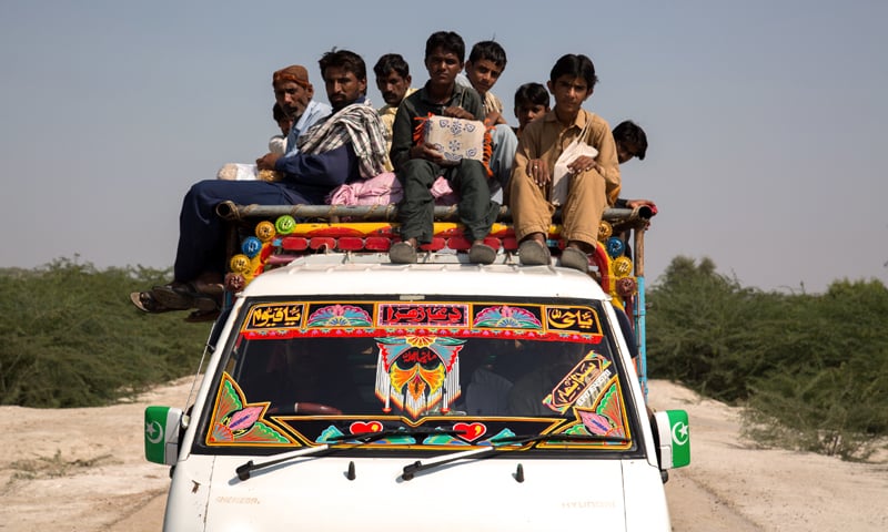 Sitting atop the bus in the blazing sun, students travel as far as 60 km from Bhakuo in Tharparkar to go to school