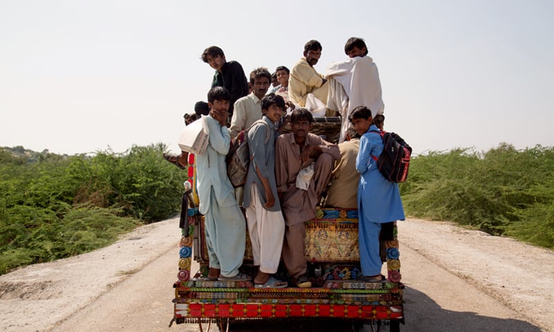 Standing in a pick-up is the only option to get to school for some students