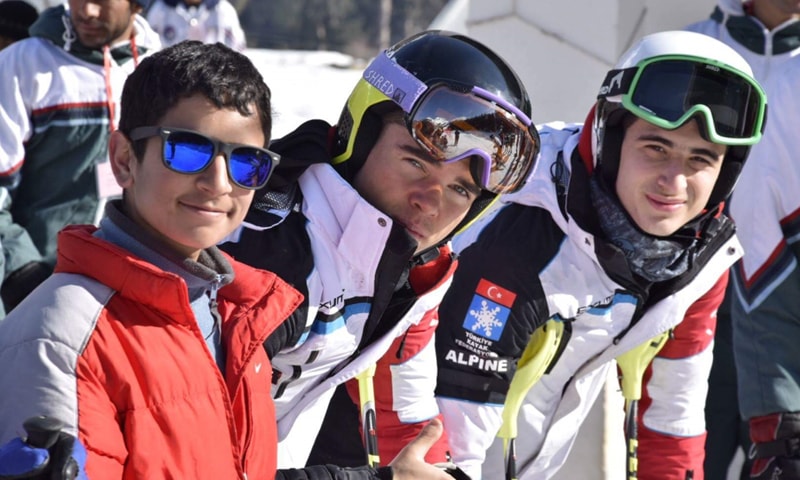 Fazal (L) with international skiiers from Turkey