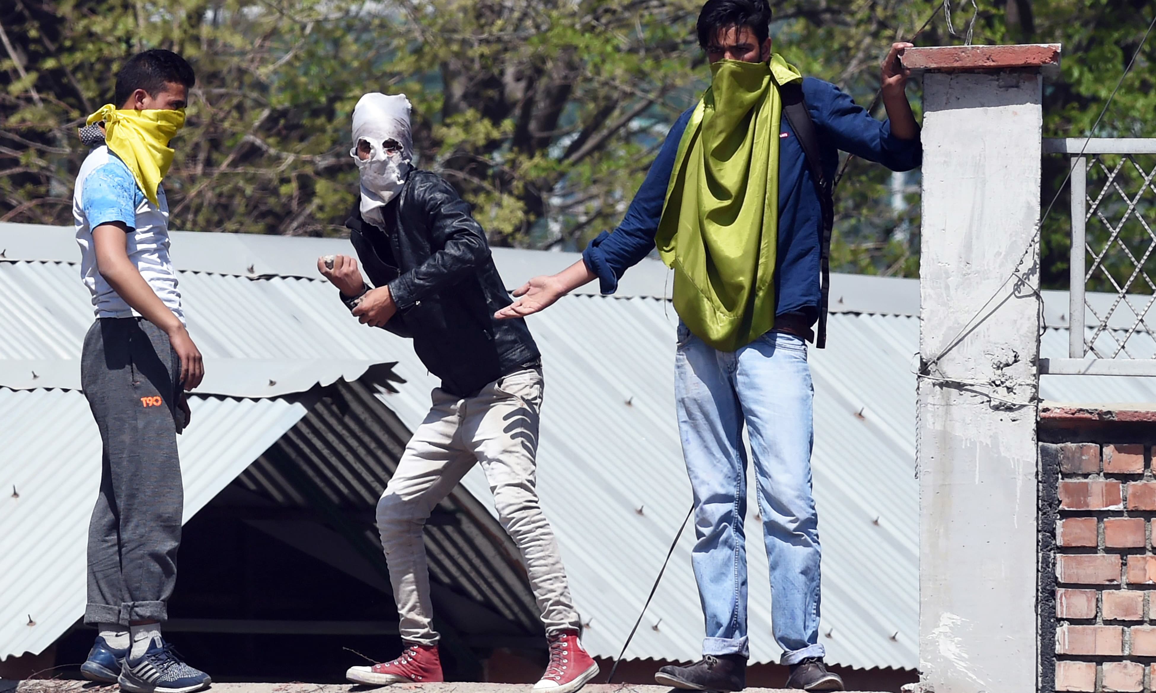 Students throw stones during clashes with Indian government forces near a college in central Srinagar's Lal Chowk. &mdash;AFP