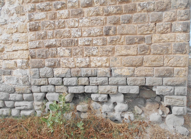 Stones have been removed from the base of a wall of the Neelah police rest house.