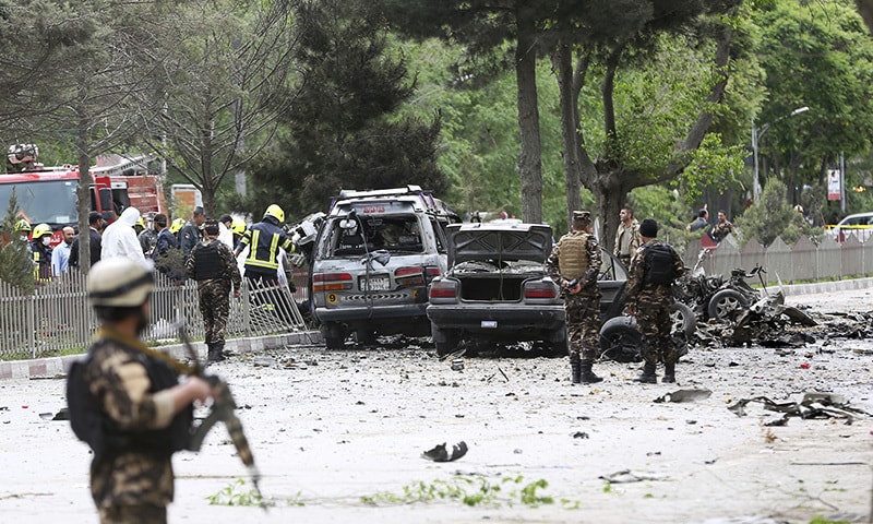 Security forces inspect at the site of a suicide attack in Kabul.— AP