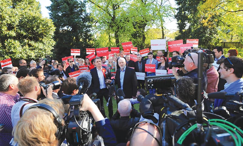 Liverpool: Media and party supporters gather around Labour Party leader Jeremy Corbyn (centre right) meeting Steve Rotheram (centre left) after he was elected as the Liverpool City Region metro mayor on Friday.—AP