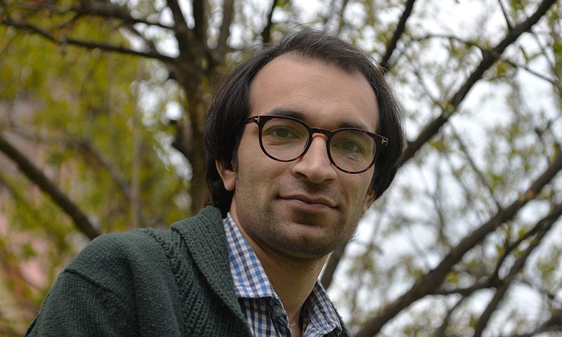 Kashmiri cartoonist Malik Sajad poses for a photograph at his home in Srinagar. ─AFP