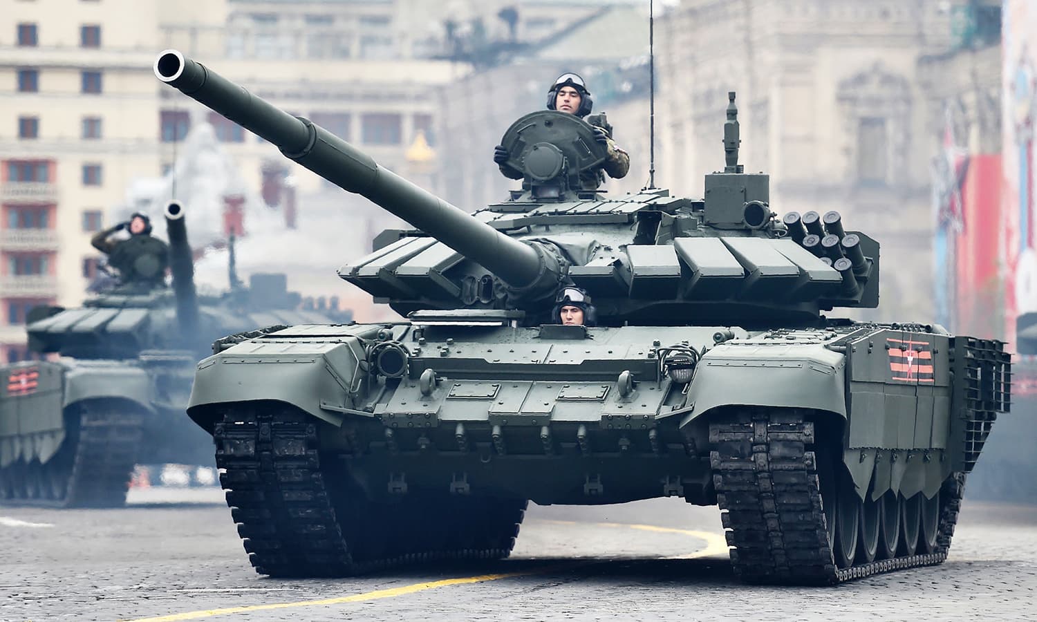 Russian T-72B3 main battle tanks ride through Red Square. -AFP