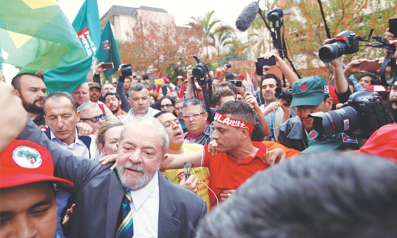 FORMER Brazilian President Luiz Inacio Lula da Silva (centre) is greeted by supporters as he arrives at the Federal Justice building in Curitiba on Wednesday to appear before Judge Sergio Moro, who is overseeing the so-called &ldquo;Car Wash&rdquo; investigation that has led to the convictions of dozens of politicians since it began three years ago.&mdash;Reuters
