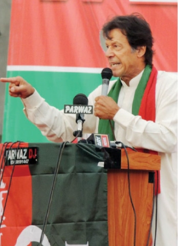 Imran Khan addressing a public meeting in Abbottabad on Sunday. — Dawn