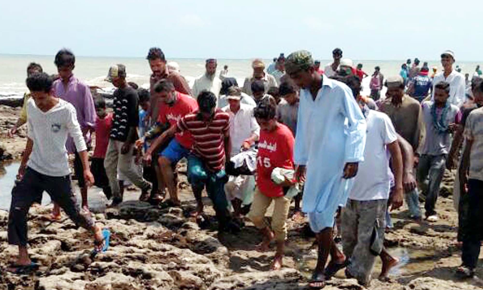 Bodies being shifted to hospital from Hawksbay Beach. —PPI