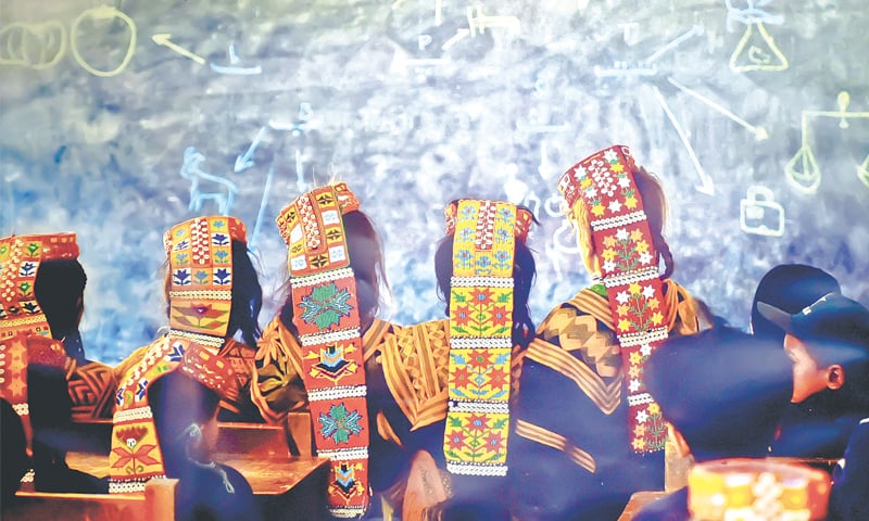 Kalash students attend a class at a school in the Brun village of Bumboret Valley.