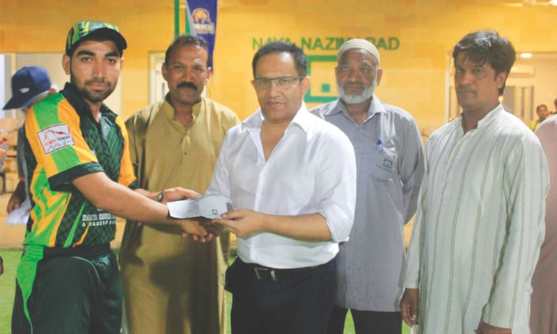 KARACHI: Former Pakistan Test batsman Shoaib Mohammad presents the man-of-the-match award to PIA spinner Ghulam Mohammad.