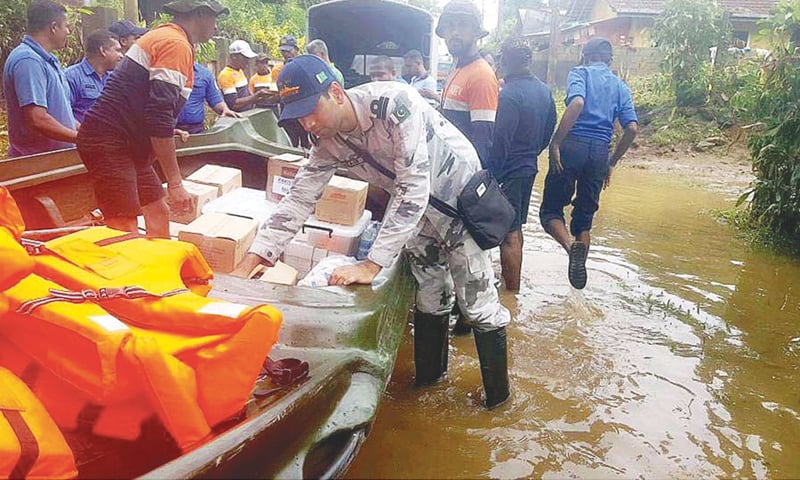 COLOMBO: A Pakistan Navy team carrying out relief and rescue operation in a flood-hit area. Over 350 patients were provided medical aid and water supply to many areas was restored after decontamination of over 40 wells.&mdash;APP