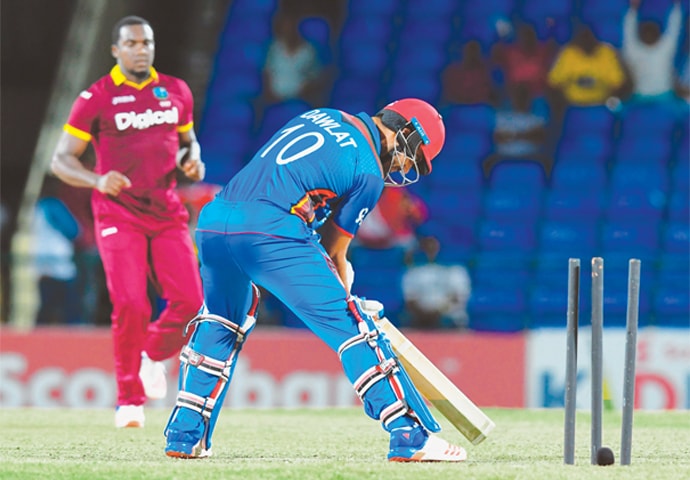 BASSETERRE: Afghanistan tailender Dawlat Zadran is bowled by West Indies fast bowler Jerome Taylor during the second Twenty20 International at Warner Park.&mdash;AFP